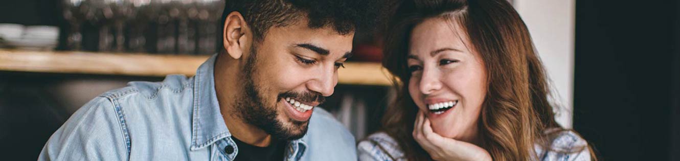 Couple smiling at each other.